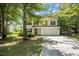 Charming two-story home with white siding, black shutters, and a two-car garage at 709 Woodgreen Dr, Durham, NC 27704