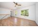 Upstairs hallway area with wood floors, white walls, and natural light from two windows at 709 Woodgreen Dr, Durham, NC 27704