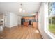 Well-lit kitchen area with light wood cabinets, hardwood flooring, and a black refrigerator at 709 Woodgreen Dr, Durham, NC 27704
