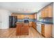 Kitchen with wood cabinets, black appliances, a center island, and track lighting at 709 Woodgreen Dr, Durham, NC 27704