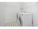 Well-organized laundry room with front load washer and dryer and white wire shelving at 709 Woodgreen Dr, Durham, NC 27704
