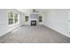 Spacious living room with fireplace, plush carpet, and bright natural light at 709 Woodgreen Dr, Durham, NC 27704