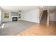 Cozy living room with fireplace, plush carpet, and natural light from large windows at 709 Woodgreen Dr, Durham, NC 27704