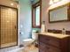 Updated bathroom features a glass-enclosed shower and a stylish vanity with granite countertop at 714 Spring Ln, Sanford, NC 27330