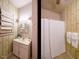 Small bathroom features vanity, window and shower at 714 Spring Ln, Sanford, NC 27330