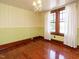 Inviting bedroom with hardwood floors, charming striped wallpaper, and abundant natural light at 714 Spring Ln, Sanford, NC 27330