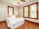 Cozy bedroom with hardwood floors, natural light, and comfortable bed at 714 Spring Ln, Sanford, NC 27330