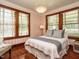 Charming bedroom features three large windows and a comfortable full sized bed at 714 Spring Ln, Sanford, NC 27330