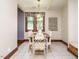 Bright dining room with wood-framed windows, table with seating, and tile flooring at 714 Spring Ln, Sanford, NC 27330
