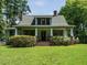 Charming home featuring a front porch with columns and a well-manicured lawn at 714 Spring Ln, Sanford, NC 27330