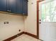 Laundry room with tile floor, cabinet space and back door leading to the outside at 714 Spring Ln, Sanford, NC 27330