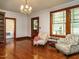 Bright living room featuring hardwood floors, a chandelier, and decorative arm chairs at 714 Spring Ln, Sanford, NC 27330
