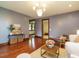 Inviting living room features hardwood floors, neutral paint, and a decorative chandelier at 714 Spring Ln, Sanford, NC 27330