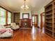Well-lit living room featuring hardwood floors, a fireplace, and custom built-in bookshelves at 714 Spring Ln, Sanford, NC 27330