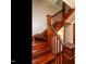 Elegant wooden staircase with detailed banister and warm lighting creates a welcoming atmosphere at 714 Spring Ln, Sanford, NC 27330