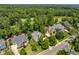 An aerial view highlighting the house and surrounding neighborhood with mature trees at 812 Bear Tree Crk, Chapel Hill, NC 27517