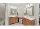 Bathroom with double vanity, matching mirrors, wooden cabinets, a decorative stool, and bright neutral paint at 812 Bear Tree Crk, Chapel Hill, NC 27517