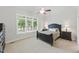 Bedroom with a large window, neutral colors, ceiling fan, and carpet floors at 812 Bear Tree Crk, Chapel Hill, NC 27517