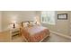 Bright bedroom featuring a patterned duvet cover and throw pillows with bedside tables and matching lamps at 812 Bear Tree Crk, Chapel Hill, NC 27517