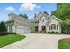 An attractive home exterior features a three-car garage, and manicured landscaping in the front yard at 812 Bear Tree Crk, Chapel Hill, NC 27517