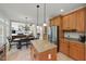 Open concept kitchen with granite island and stainless steel appliances flows into a living room with a fireplace at 812 Bear Tree Crk, Chapel Hill, NC 27517