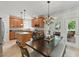 Bright eat-in kitchen features a kitchen island, stainless steel appliances, and a stylish chandelier at 812 Bear Tree Crk, Chapel Hill, NC 27517
