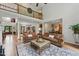 Open concept living room with wood floors, decorative columns, and staircase overlooking the room at 812 Bear Tree Crk, Chapel Hill, NC 27517