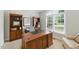 Bright office featuring hardwood furniture, built-in shelving, and natural light from a large window at 812 Bear Tree Crk, Chapel Hill, NC 27517