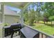 Back patio area with barbecue and green backyard with grass at 812 Bear Tree Crk, Chapel Hill, NC 27517