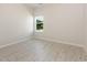 Bright bedroom featuring light wood-look floors, neutral walls, and natural light from a window at 823 Biltmore Dr, Sanford, NC 27332