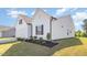 Side view of a well-maintained home with a two-car garage and manicured landscaping at 823 Biltmore Dr, Sanford, NC 27332