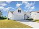 Rear view of a well-maintained home with a two-car garage and a spacious yard at 823 Biltmore Dr, Sanford, NC 27332