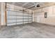 Spacious two-car garage featuring a garage door and concrete flooring at 823 Biltmore Dr, Sanford, NC 27332