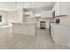 Modern kitchen with stainless steel appliances, light countertops, and stylish white cabinets at 823 Biltmore Dr, Sanford, NC 27332