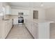 Spacious kitchen with stainless steel appliances, light countertops, white cabinets and an island at 823 Biltmore Dr, Sanford, NC 27332