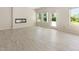 Bright living room features a modern fireplace, plenty of natural light, and stylish light wood flooring at 823 Biltmore Dr, Sanford, NC 27332