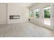 Bright living area with large windows, a modern fireplace, and seamless access to an outdoor patio at 823 Biltmore Dr, Sanford, NC 27332