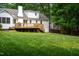 Expansive backyard featuring a well-maintained lawn and a spacious wooden deck at 8604 Timberwind Dr, Raleigh, NC 27615