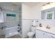 Bathroom featuring soaking tub, glass shower, white subway tile, and vanity with modern fixtures at 8604 Timberwind Dr, Raleigh, NC 27615