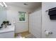 Bright bathroom with a window, vanity, white shower curtain, and decorative towels for a clean aesthetic at 8604 Timberwind Dr, Raleigh, NC 27615