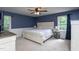 Primary bedroom with carpeted floor, paneled wall, natural light, and ceiling fan at 8604 Timberwind Dr, Raleigh, NC 27615