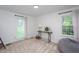 Bedroom featuring neutral carpet, natural light, and versatile seating area with comfortable bean bag at 8604 Timberwind Dr, Raleigh, NC 27615