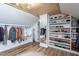 Large closet space featuring custom shelving for shoes and clothes, finished with a round mirror for style at 8604 Timberwind Dr, Raleigh, NC 27615