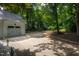 Long driveway leading to detached garage and featuring a basketball hoop for recreation on a large private lot at 8604 Timberwind Dr, Raleigh, NC 27615