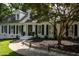 Charming home featuring a meticulously landscaped front yard with lush green grass, plants and a paved walkway to the front door at 8604 Timberwind Dr, Raleigh, NC 27615