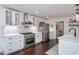 Modern kitchen featuring white cabinetry, stainless steel appliances, subway tile backsplash, and quartz countertops at 8604 Timberwind Dr, Raleigh, NC 27615