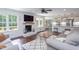 Open living space featuring a brick fireplace, exposed wood beam, and seamlessly connected kitchen and dining area at 8604 Timberwind Dr, Raleigh, NC 27615
