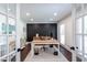 Bright office space with French doors, custom accent wall, dark hardwood floors, and a light-filled window at 8604 Timberwind Dr, Raleigh, NC 27615