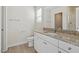 Bright bathroom featuring a granite countertop and a framed mirror at 87 Royal Meadow Dr, Angier, NC 27501