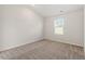 Bright bedroom featuring plush carpeting, a large window, and neutral paint at 87 Royal Meadow Dr, Angier, NC 27501